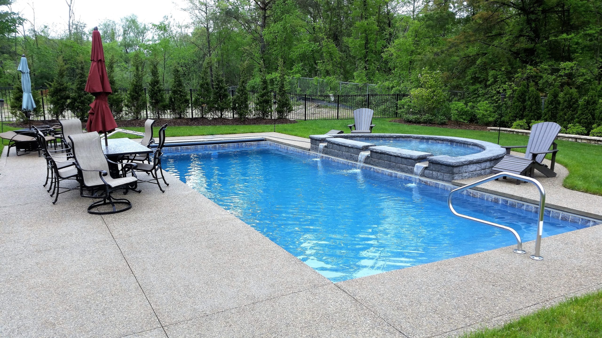 BH-Apollo_BHP-scaled rectangle inground fiberglass pool with spa that spill into the long edge of the pool